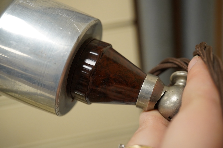 A pair of industrial-style photography aluminium shaded spot-lights on Bakelite stands, 29cm high. Condition - shades scratched from use, untested if working